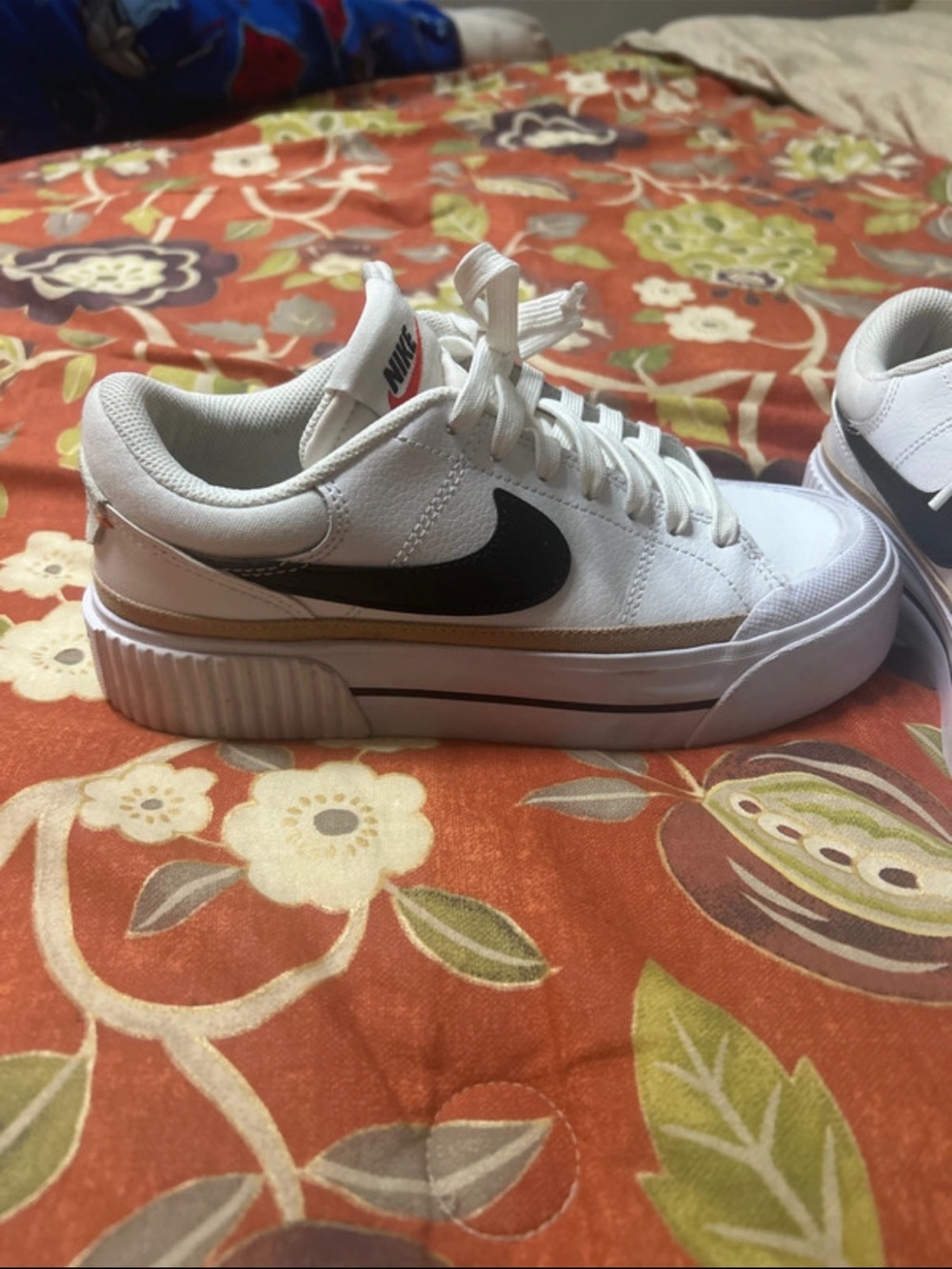 Nike Kids White Sneakers with Black Swoosh and Gold Trim
